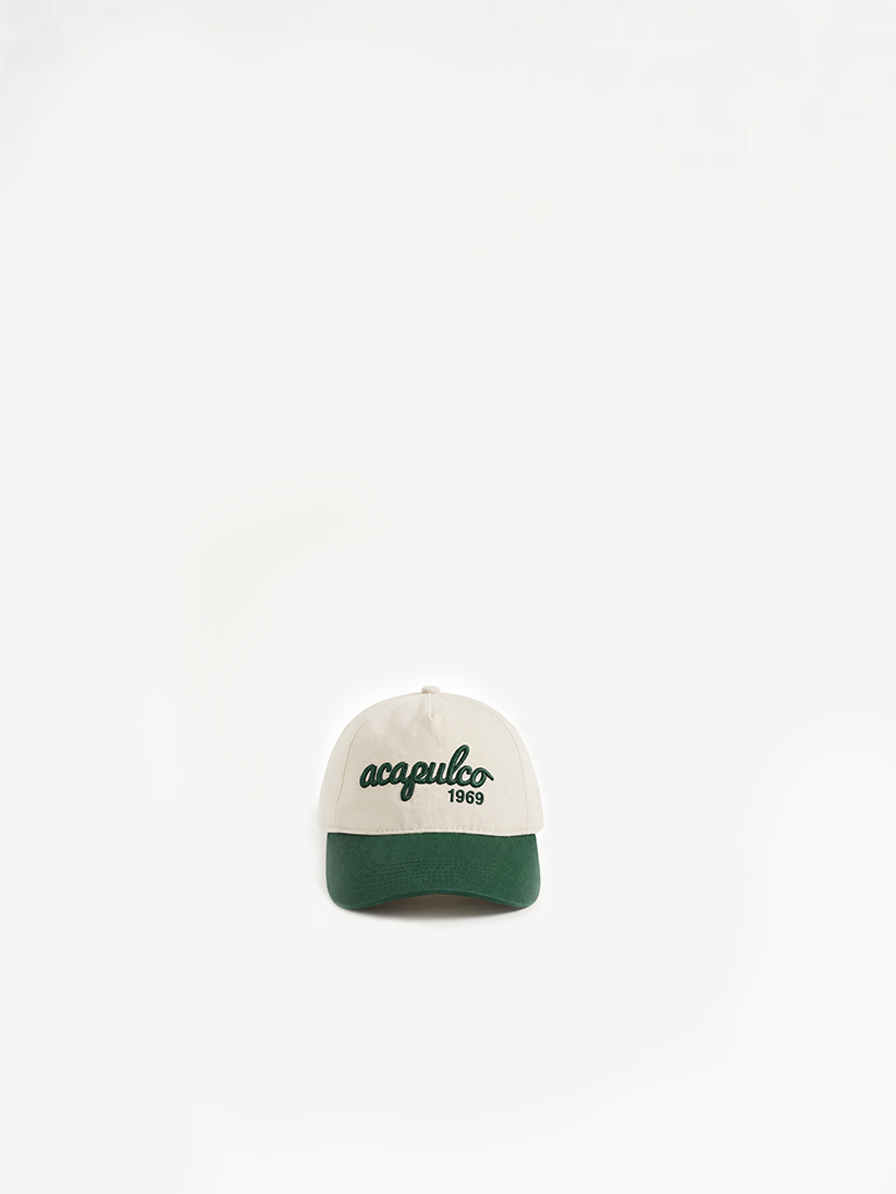 The Acapulco Cap in ecru and green — front view with Acapulco embroidery, numbered-run padel cap