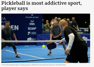 Players competing in a fast-paced pickleball match on an indoor blue court at the 2025 English Open