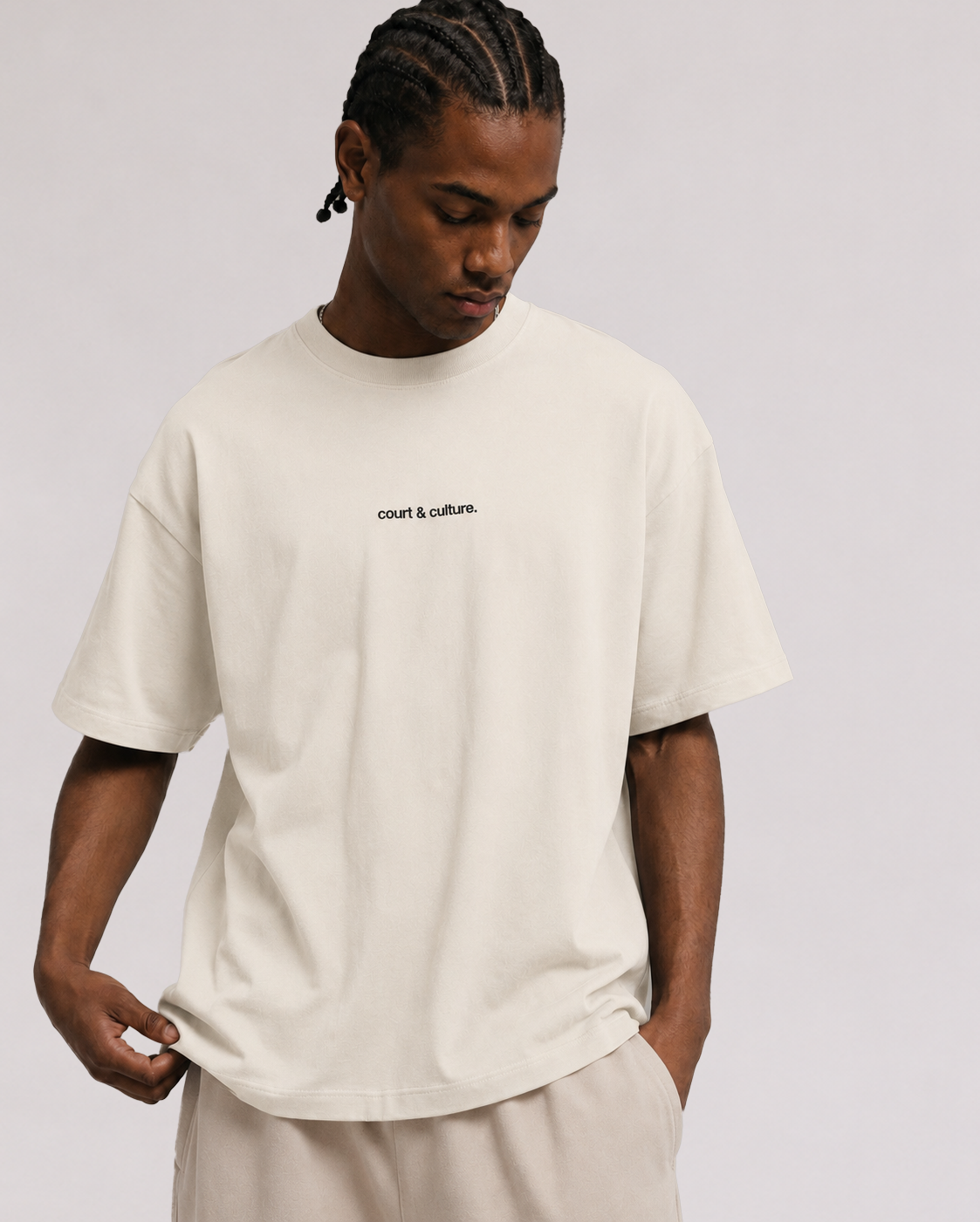 Third Shot Model wearing a stone coloured boxy fit court and culture T-shirt 