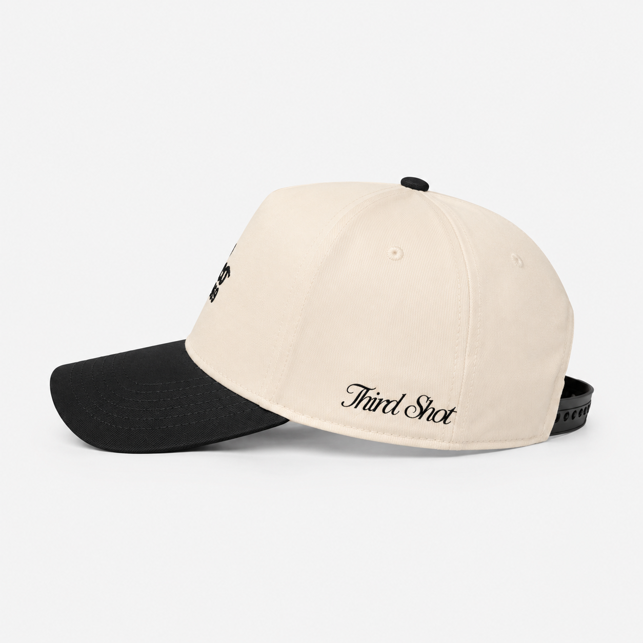 The Acapulco Cap in charcoal and cream — side view with Third Shot embroidery