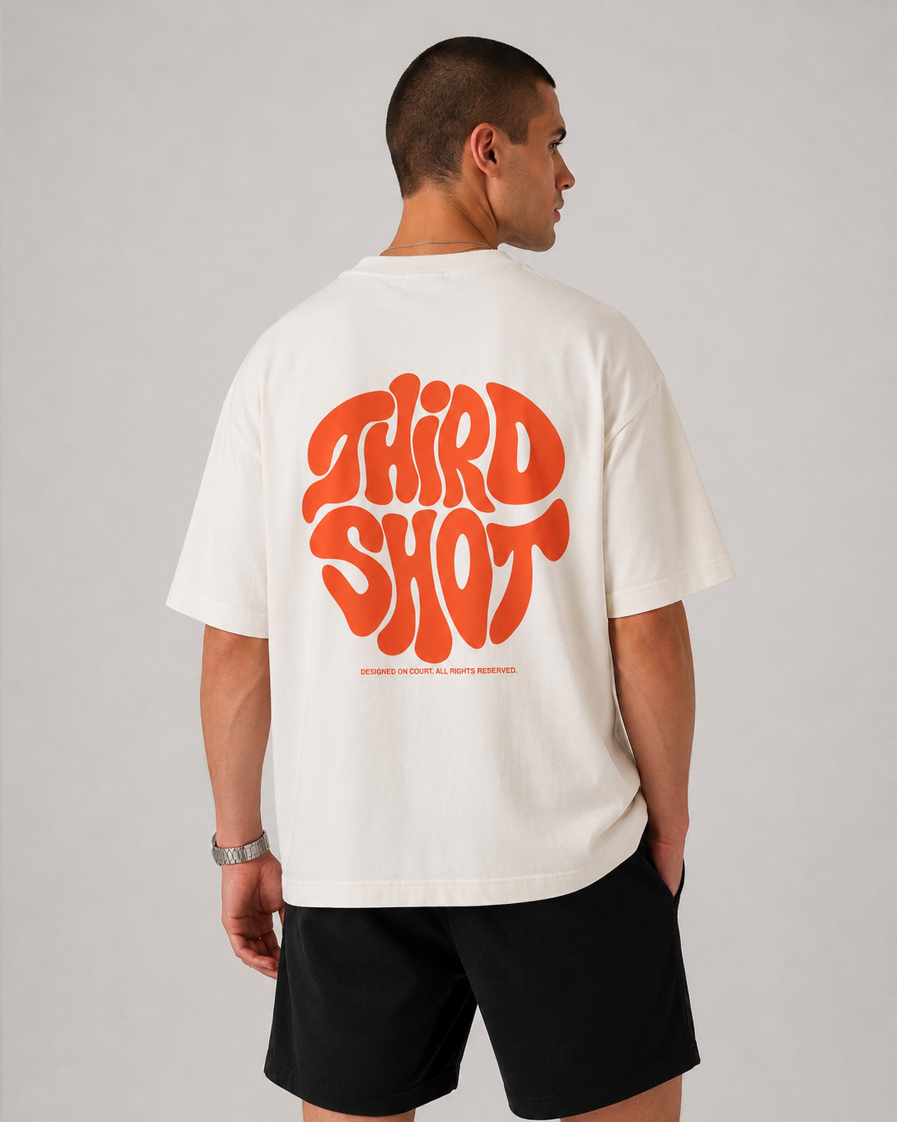 Retro Tee in ecru and orange — flat-lay on court turf, Third Shot heavyweight graphic tee